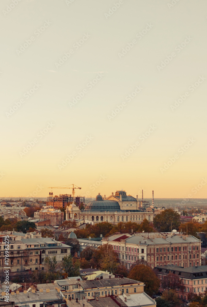 aerial view to Odessa, roofs, port and sea at sunset or sunrise 