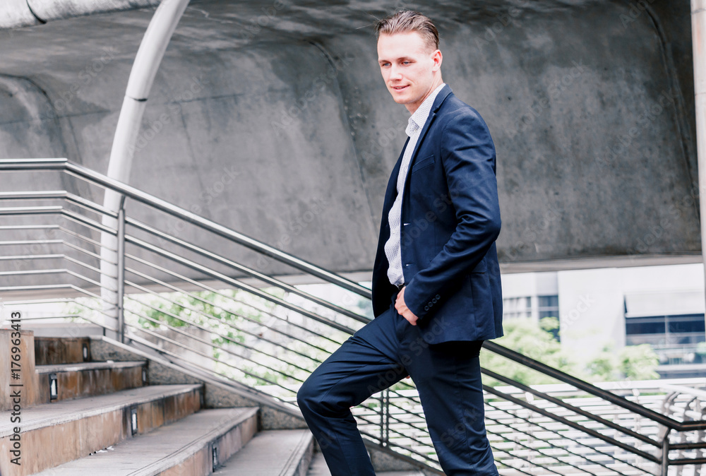 Businessman walking up the stairs Businessman walking up the stairs