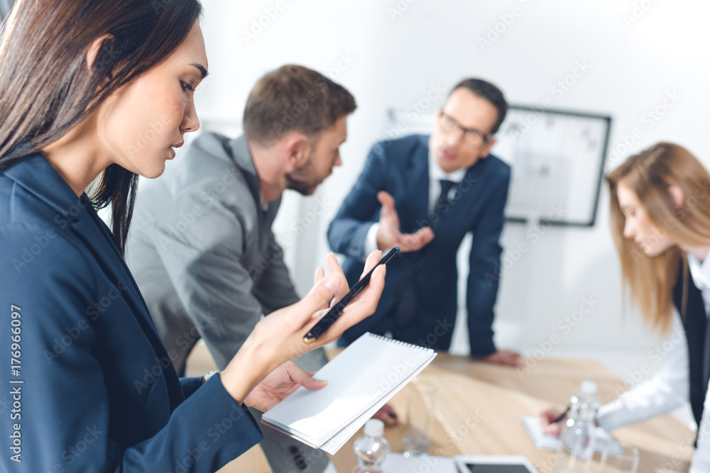 asian businesswoman looking at notebook