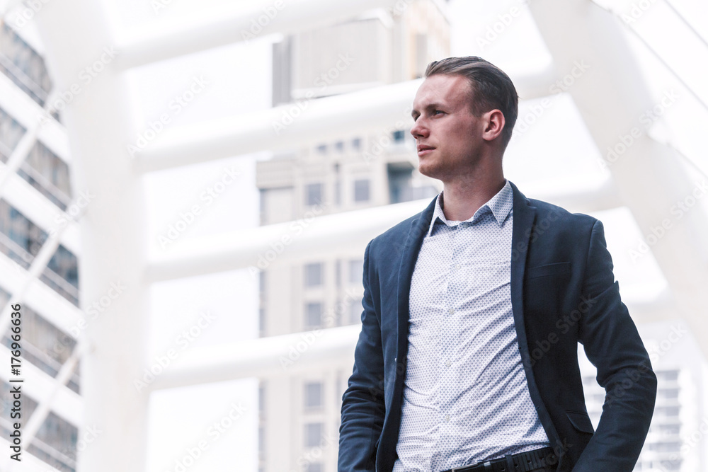 Portrait of handsome man in black suit standing outdoors Portrait of handsome man in black suit standing outdoors