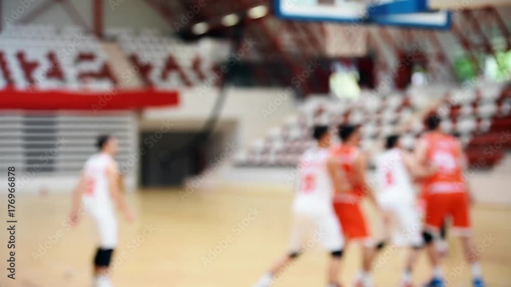 Basketball match scene with players unfocused in the background Basketball match scene with players unfocused in the background