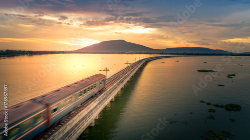 The train was running at high speed through a railway bridge Over Lake Pa Sak Dam Lopburi Thailand Beautiful Sunset