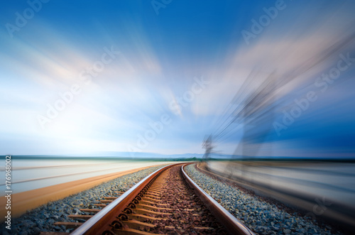 Motion on railroad bridge curve track over the lake, Blue Sky