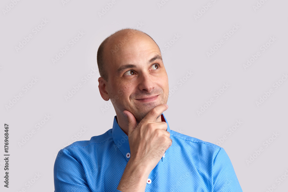 Smiling man dreaming. Isolated on grey Smiling man dreaming. Isolated on grey