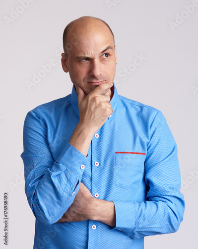 Man doubting isolated on grey