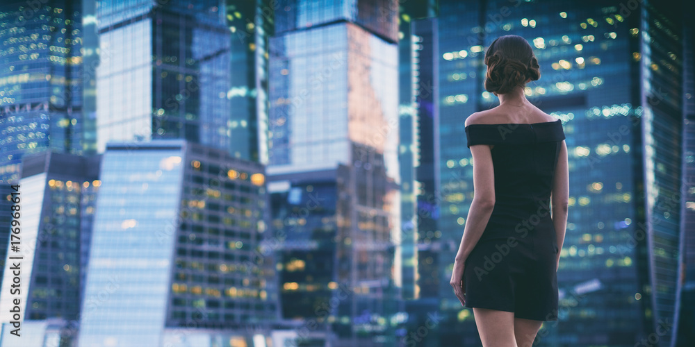 © spaxiax - woman looking at evening city © spaxiax - woman looking at evening city