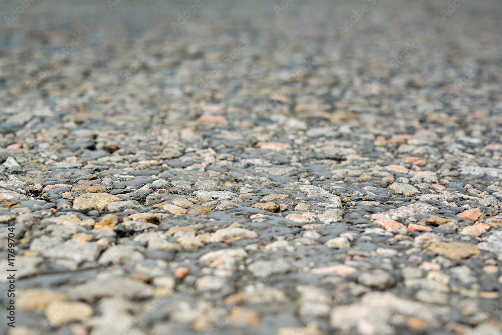 The old road, small stones and asphalt close up with a small depth of field. The old road, small stones and asphalt close up with a small depth of field.