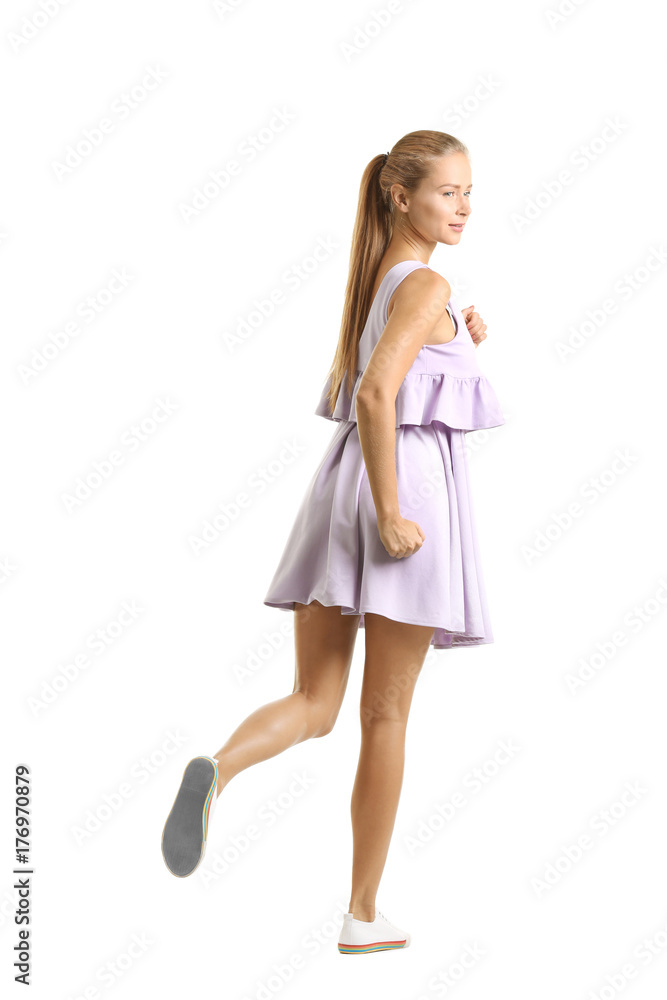 Young beautiful woman running against white background Young beautiful woman running against white background