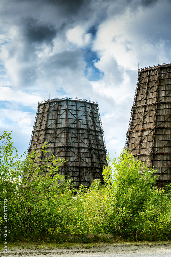 Cooling towers against the background of beautiful mountains and blue sky