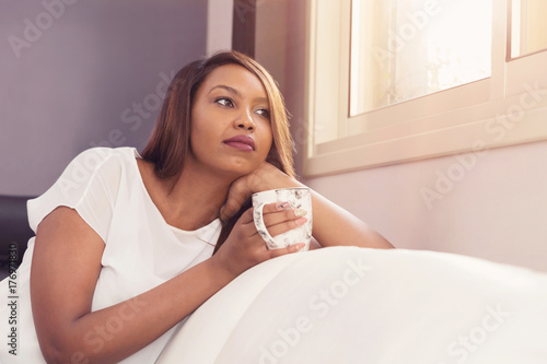 Young Lady Sitting And Relaxing By The Window