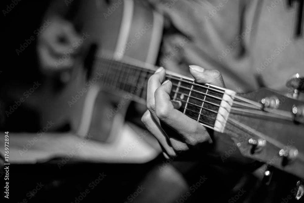 Fototapeta premium Close-up man playing acoustic guitar