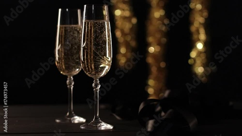 Two champagne glasses with celebration background.