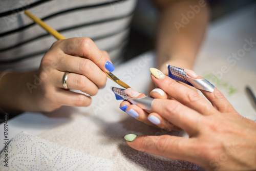 Manicure. Master make nail extension. hands closeup. photo