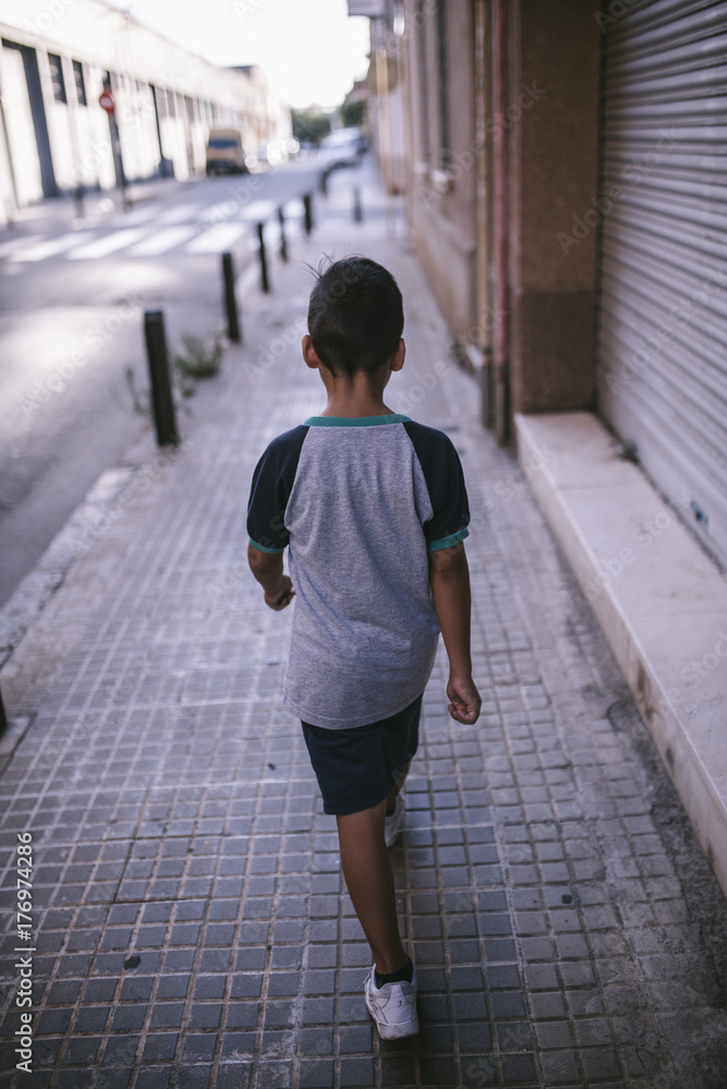 Boy walking on the street Boy walking on the street