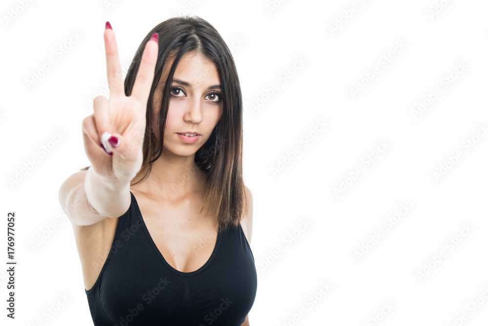Portrait of fit girl showing peace gesture
