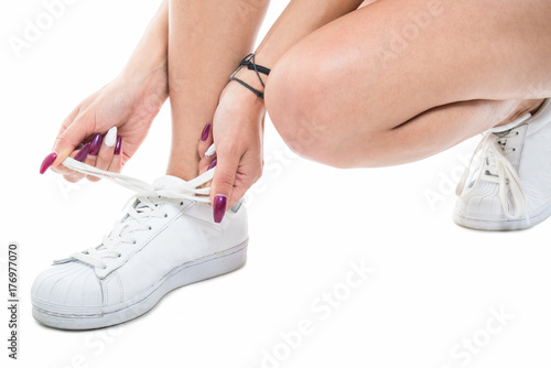 Close-up of fit girl lacing the sneakers