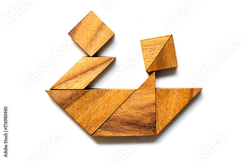 Wood tangram puzzle in boat with couple or friend shape on white background