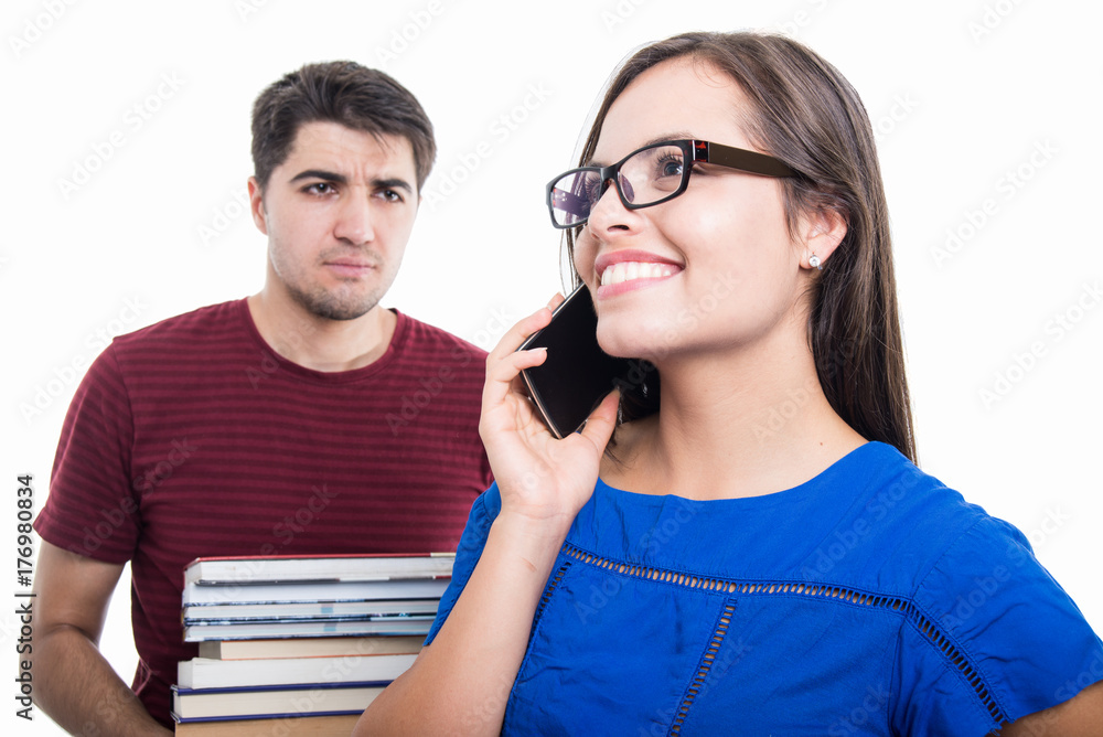 Student girl portrait talking at phone with boy caring books