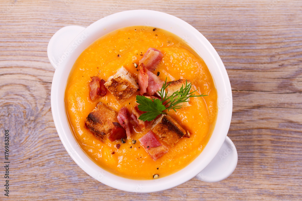 Butternut Squash and Bacon Soup in White Bowl. View from above, top studio shot, horizontal Butternut Squash and Bacon Soup in White Bowl. View from above, top studio shot, horizontal