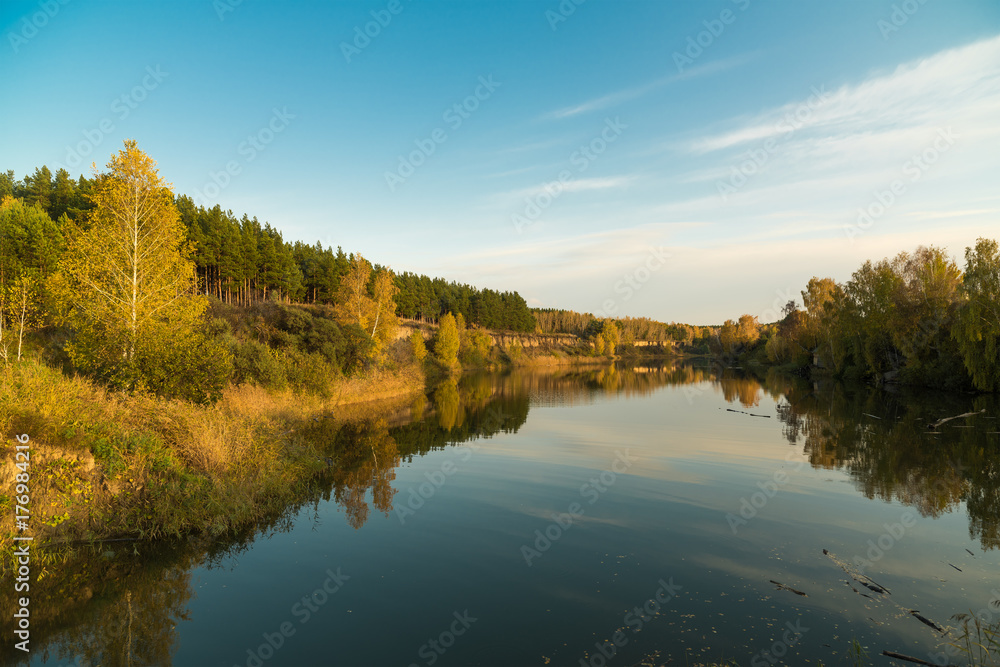 Autumn landscape on the river in the evening.