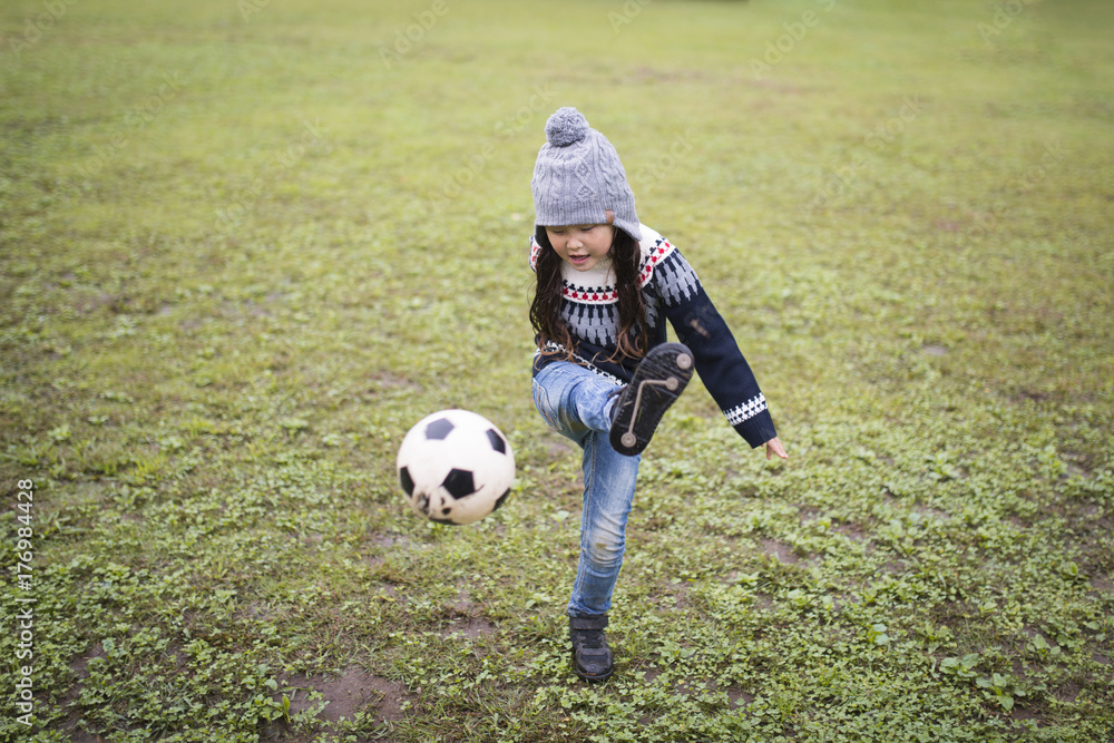Little girl playing with a soccer ball Little girl playing with a soccer ball