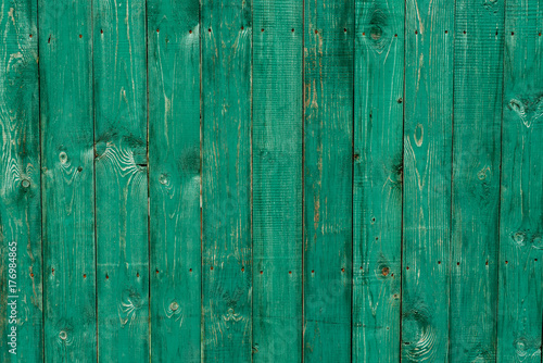 Dark lime vintage wooden boards. Backgrounds and textures fence painted. Front view. Attract a beautiful vintage background. © byswat