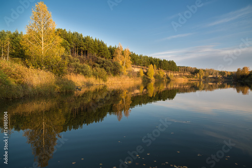 Autumn landscape on the river in the evening.