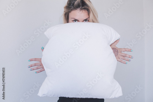 girl holds white pillow