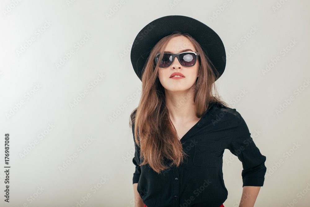 Young beautiful fashionable woman with trendy makeup in black hat and glasses on the grey background . Model looking at camera, wearing stylish eyeglasses. Female fashion, beauty concept.
Young beautiful fashionable woman with trendy makeup in black hat and glasses on the grey background . Model looking at camera, wearing stylish eyeglasses. Female fashion, beauty concept.
