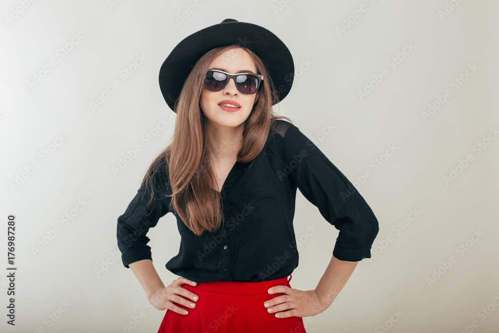 Young beautiful fashionable woman with trendy makeup in black hat and glasses on the grey background . Model looking at camera, wearing stylish eyeglasses. Female fashion, beauty concept.
Young beautiful fashionable woman with trendy makeup in black hat and glasses on the grey background . Model looking at camera, wearing stylish eyeglasses. Female fashion, beauty concept.