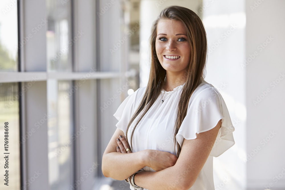 Portrait of young woman looking to camera with arms crossed Portrait of young woman looking to camera with arms crossed