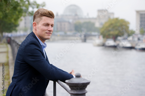 Photography blond man with german parliament in the background