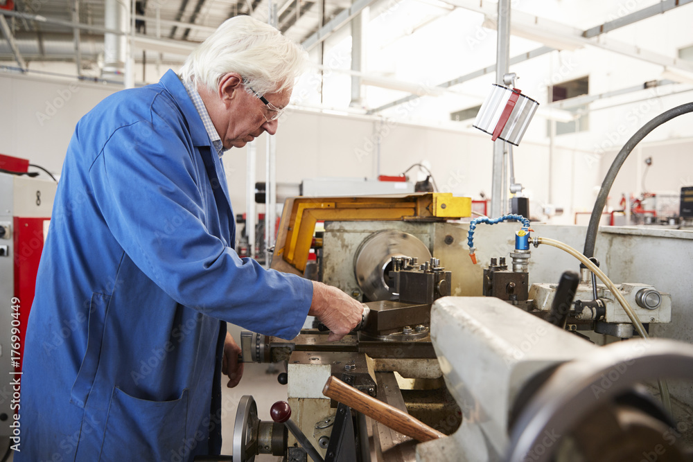 Senior engineer working in a factory, side view