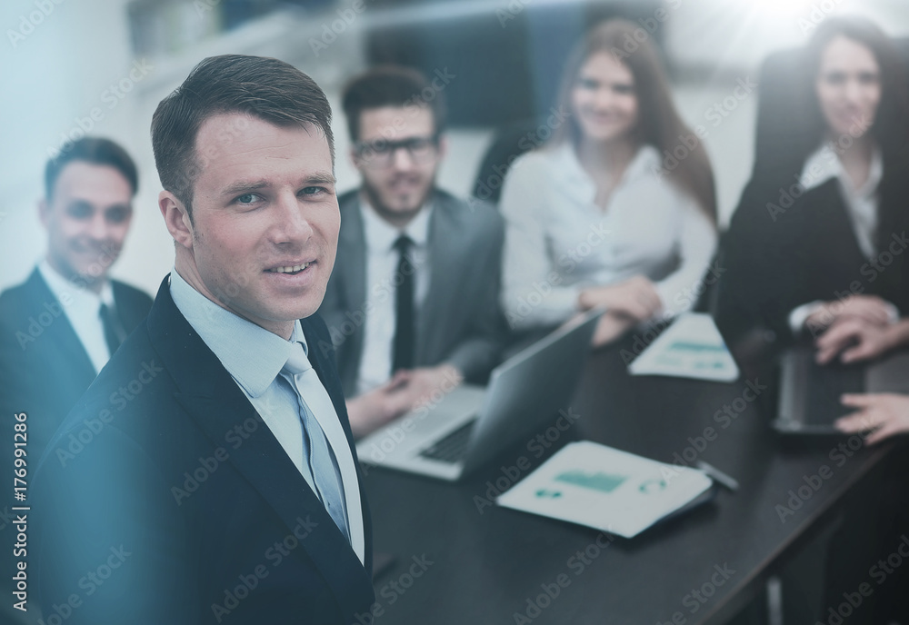 Portrait of an handsome businessman in front of his team Portrait of an handsome businessman in front of his team