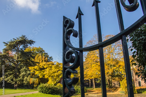 Massive cast-iron door of the superb autumn park. photo