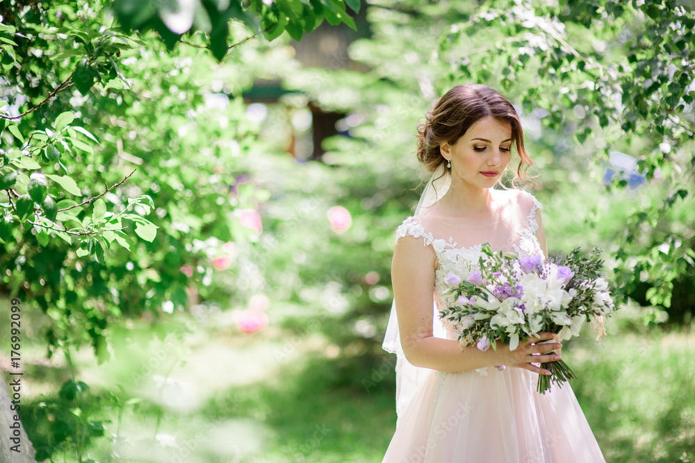 Gorgeous bride poses in the rays of light in the park Gorgeous bride poses in the rays of light in the park