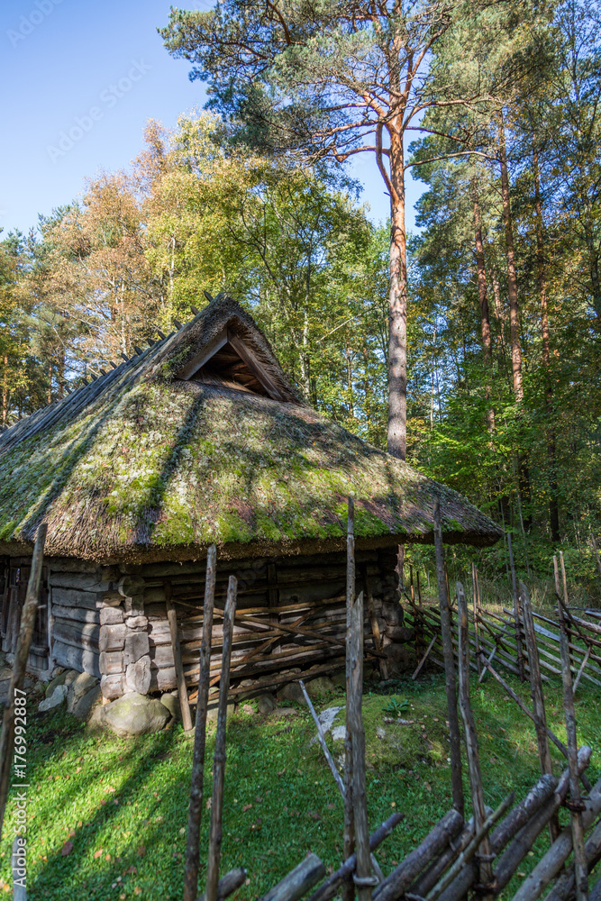 Facade of a very old wooden house in the countryside in Estonia in autumn