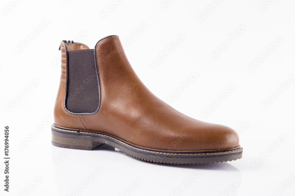 Male brown leather boot on white background, isolated product. Male brown leather boot on white background, isolated product.