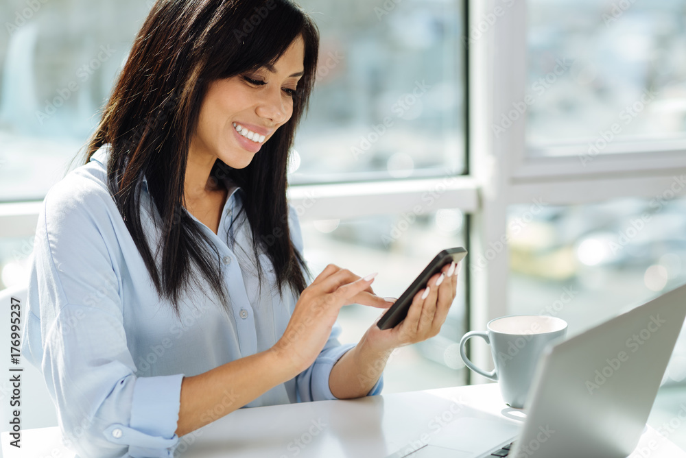 Attentive female person searching necessary number Attentive female person searching necessary number