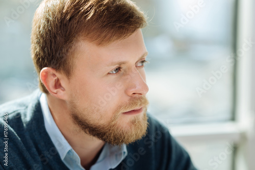 Attractive office worker being deep in thoughts