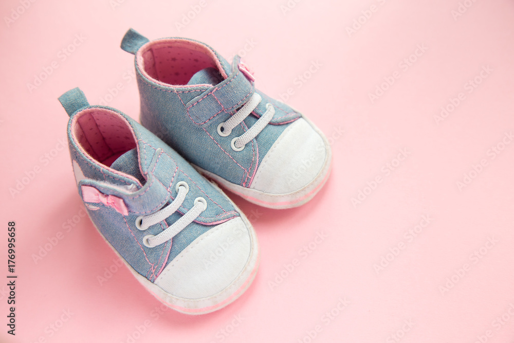Children's denim sports shoes for girls, stands on a pink background. closeup view from the top. the concept of children's clothing Children's denim sports shoes for girls, stands on a pink background. closeup view from the top. the concept of children's clothing