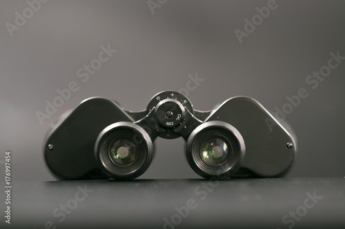 binoculars with large magnification on a monophonic background. photo