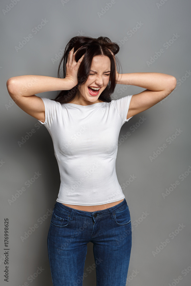 Playful woman in casual outfit, studio shot Playful woman in casual outfit, studio shot