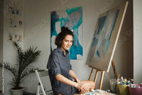 Woman draws picture in home studio. Concept of arts therapy photo