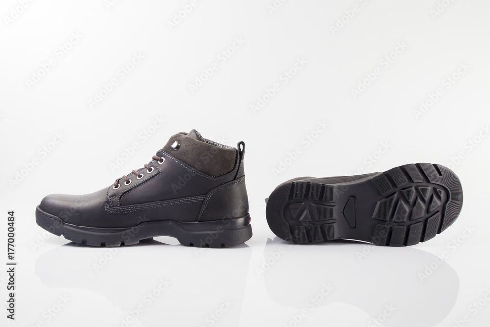 Male black leather boot on white background, isolated product. Male black leather boot on white background, isolated product.