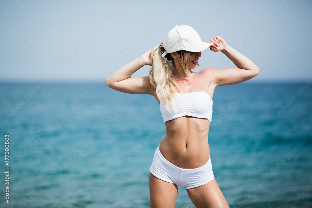 Fitness Body of Beautiful Blonde Woman on the Beach