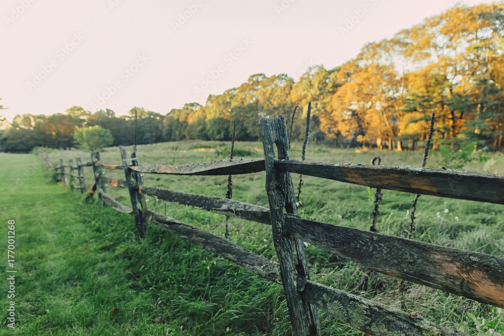 old wooden fence on the background of autumn rural landscape. farm scene. Copy space for your text