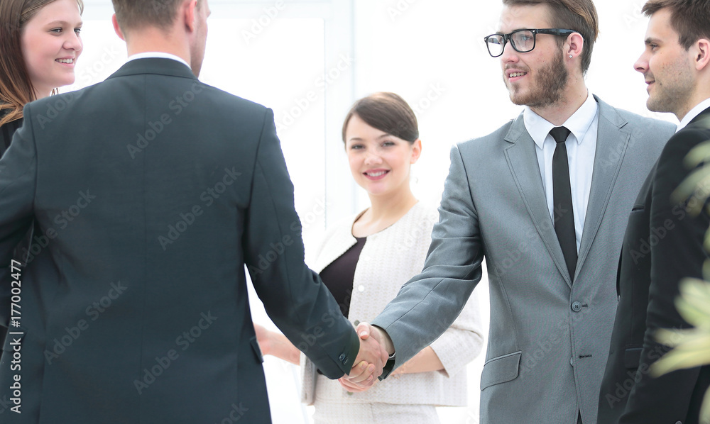 business team meets business partners in the office.a friendly h business team meets business partners in the office.a friendly h