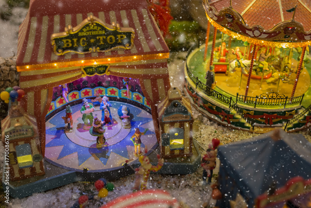 Fototapeta premium Christmas village miniature with snow and lights