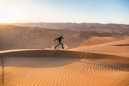 Man running alone in the desert photo